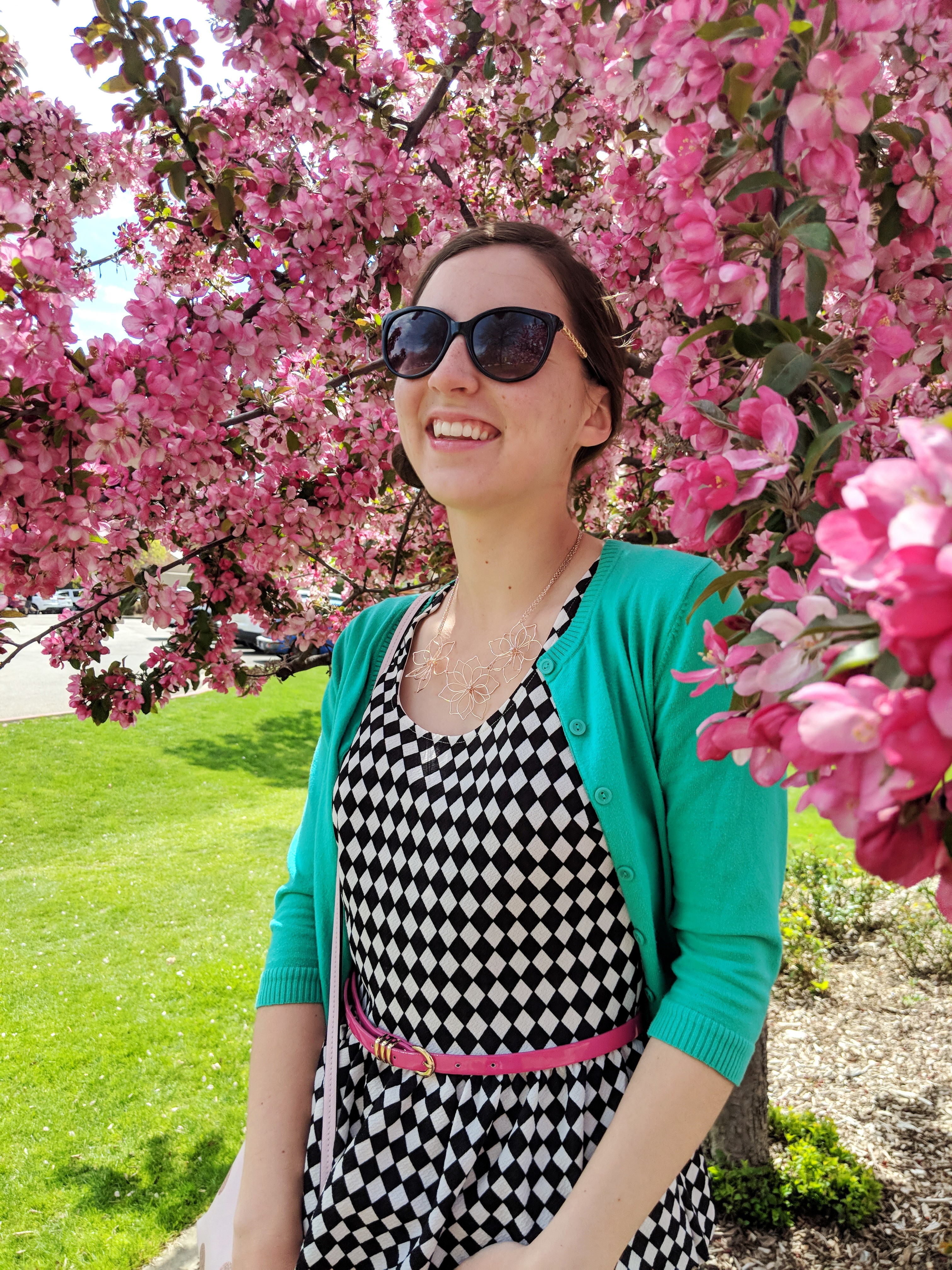 black printed peplum blouse, green cardigan, pink belt
