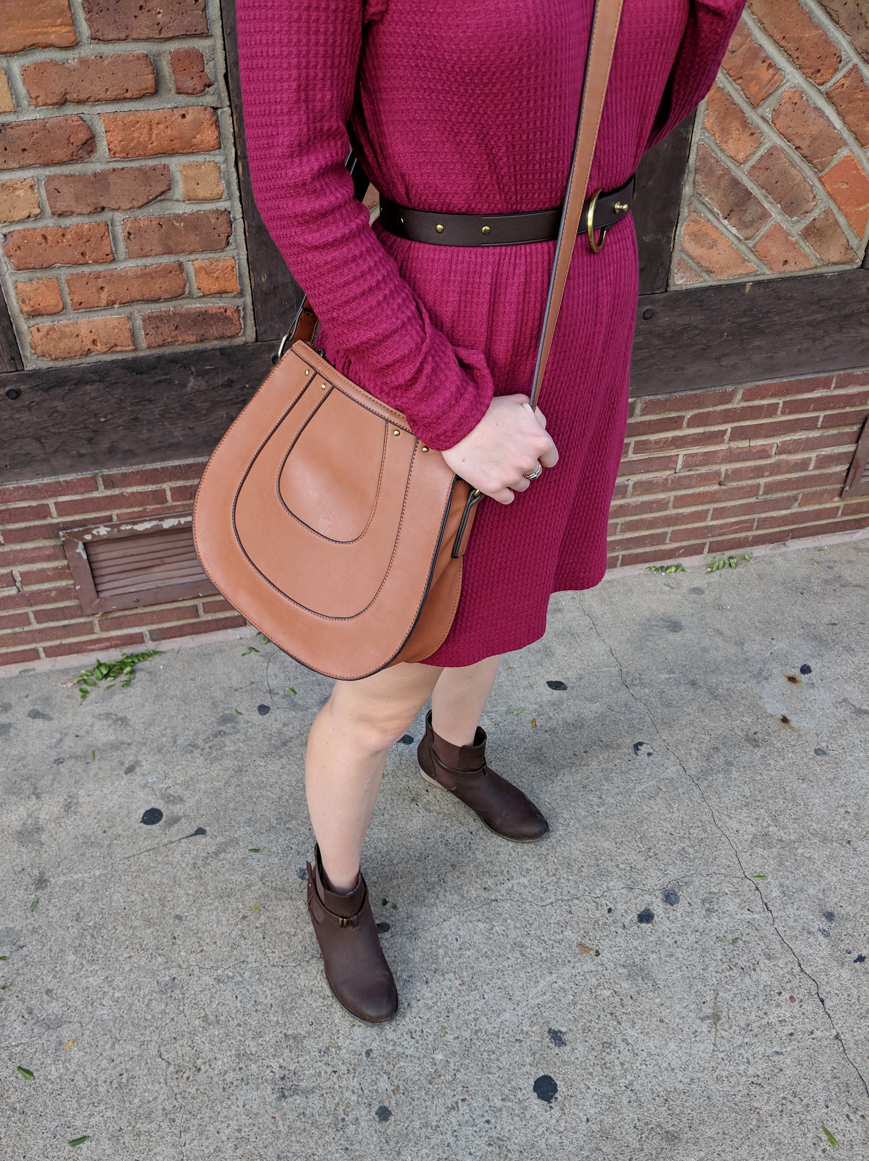 close-up of red waffle knit fabric and brown Club Monaco saddle bag