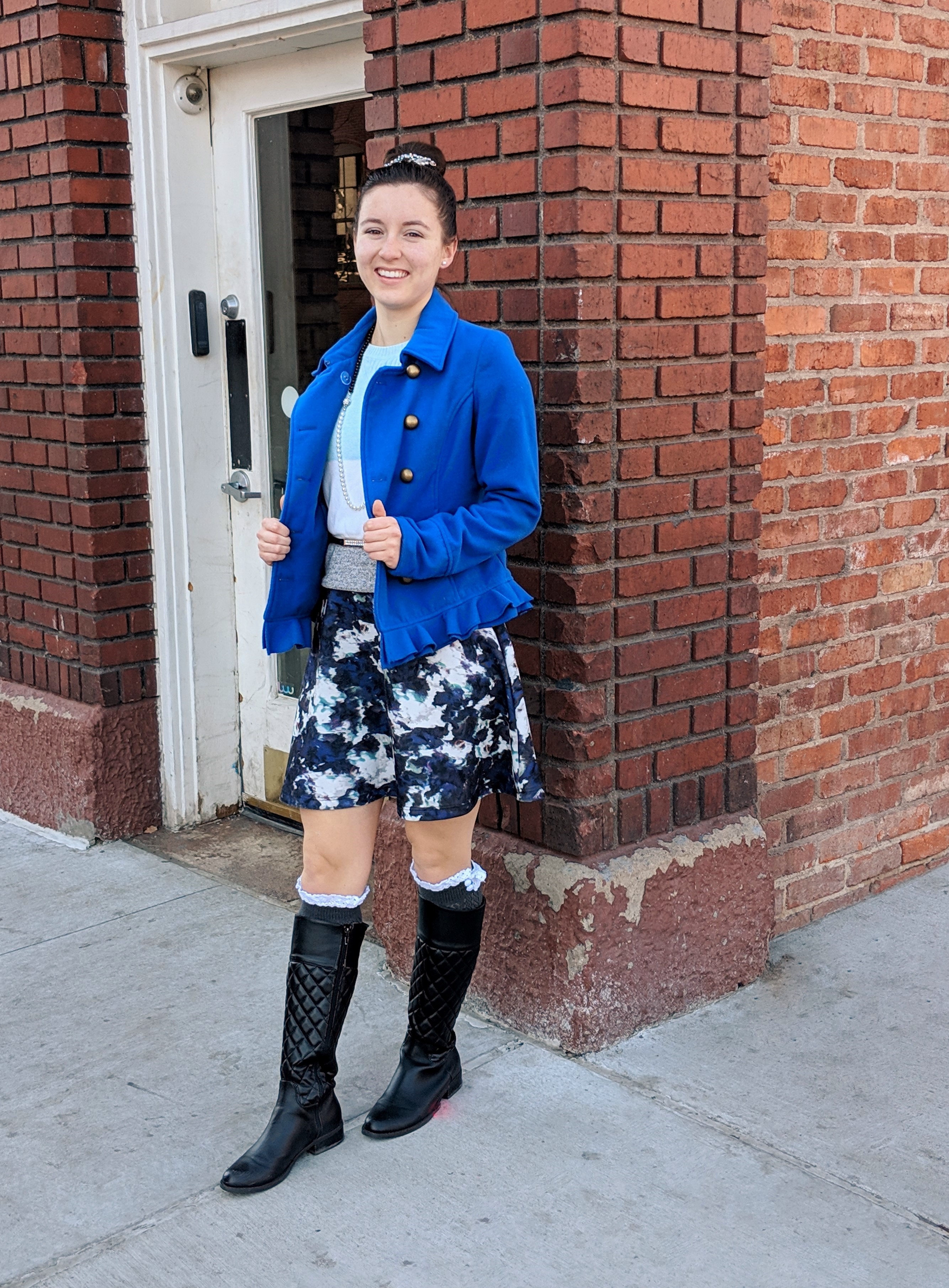 black boots blue coat patterned skirt