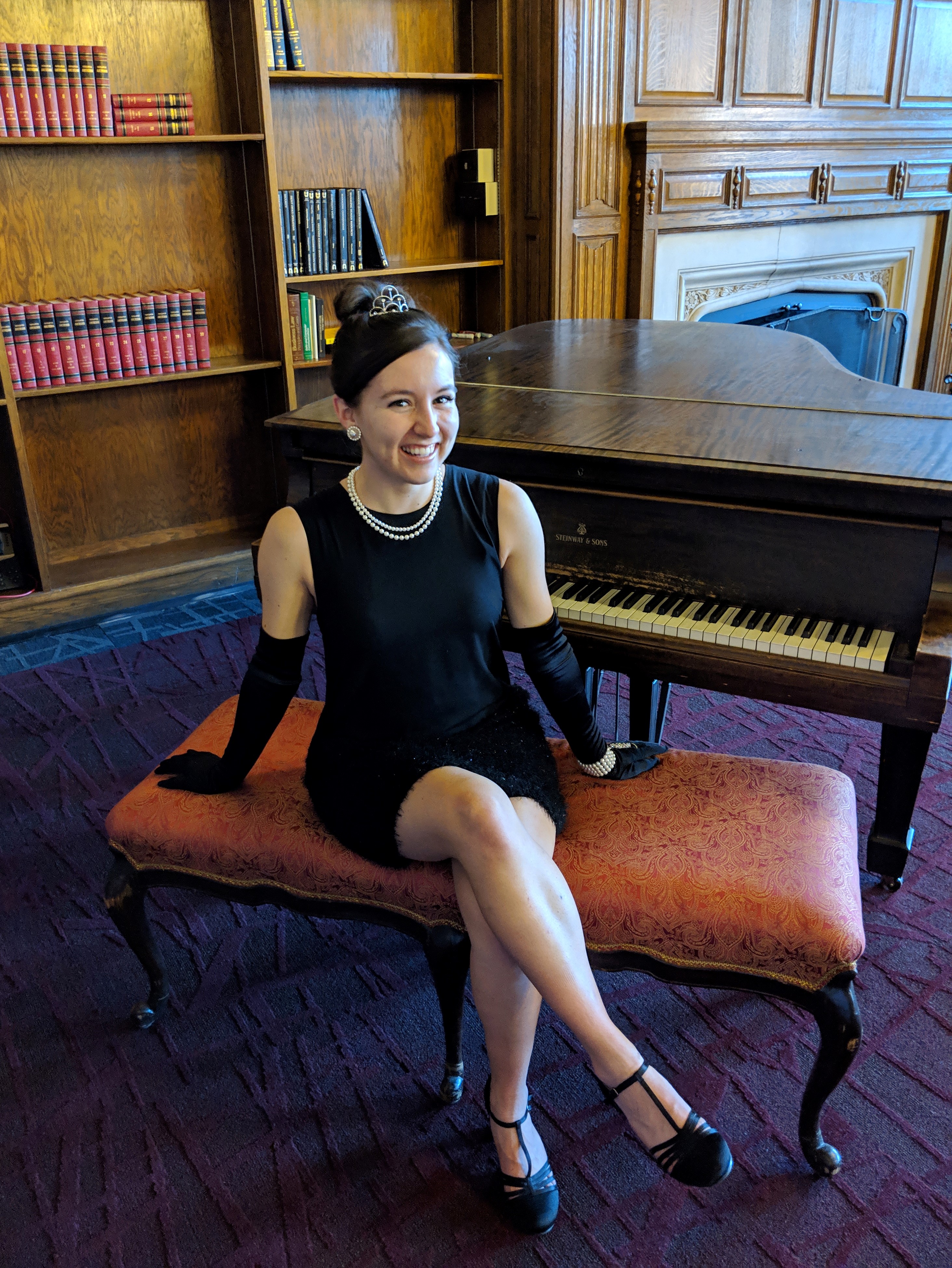 Fancy black dress and a girl sitting at a piano