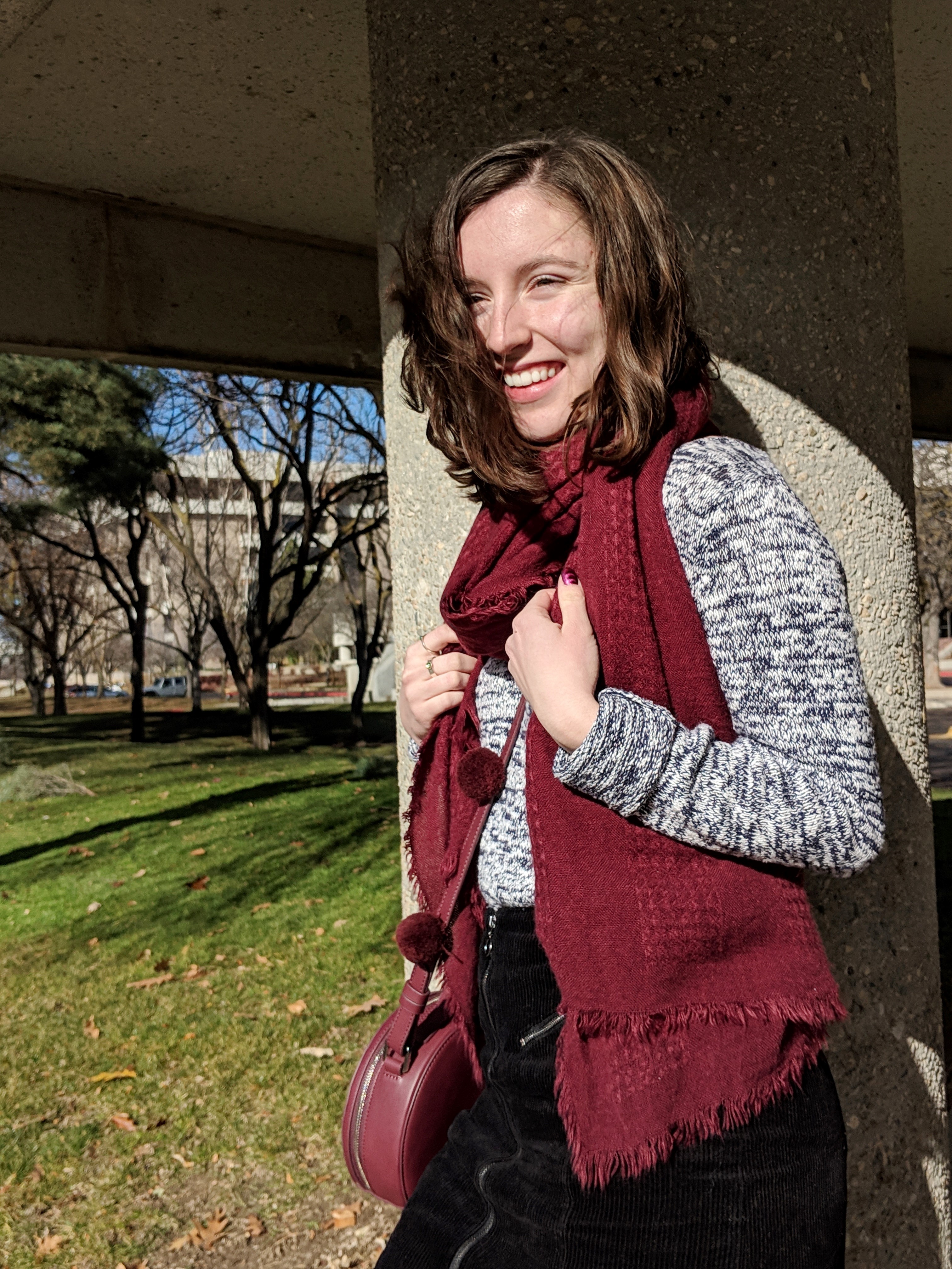 maroon scarf and maroon circle purse with pom poms