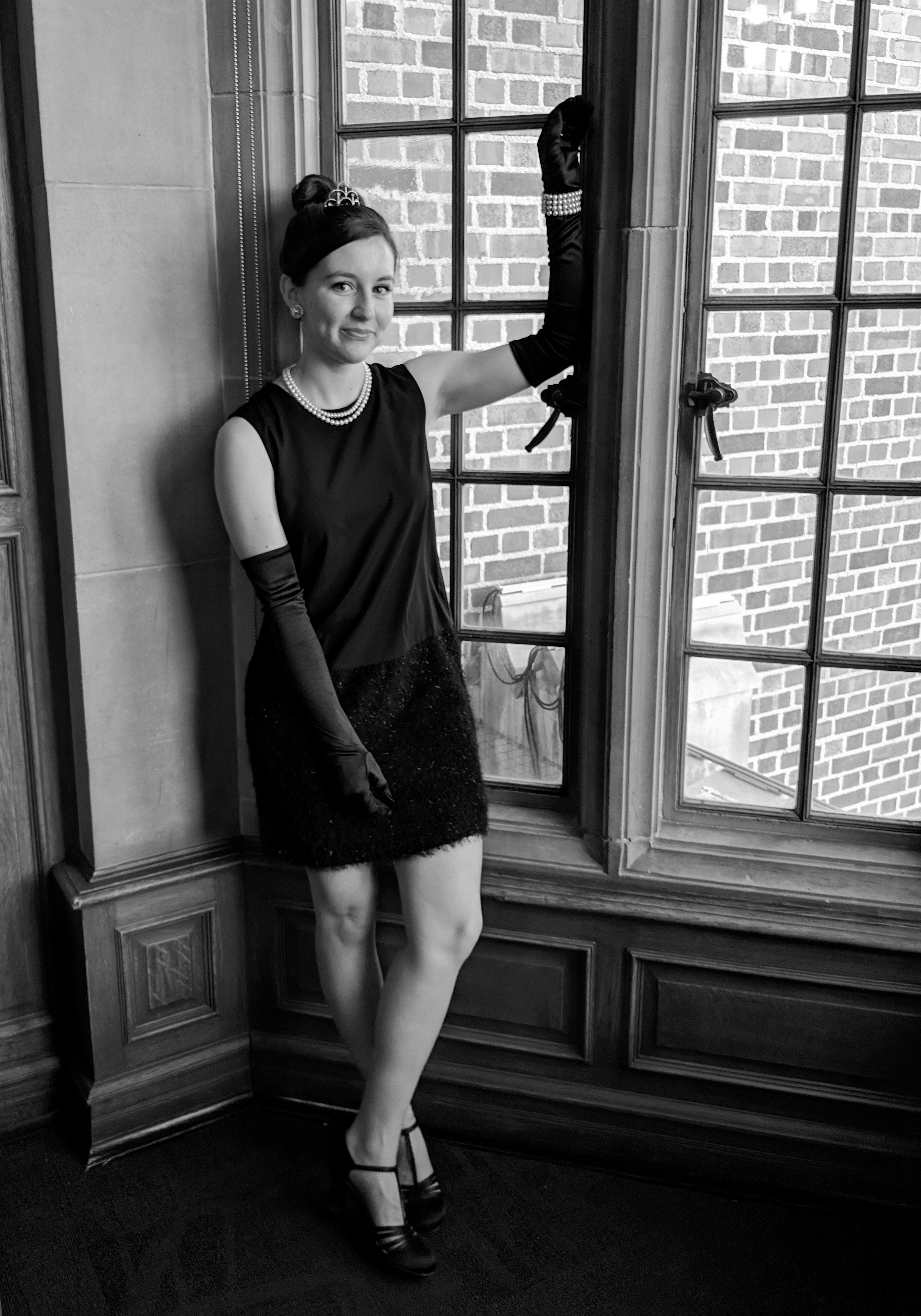 Audrey Hepburn costume leaning against a window