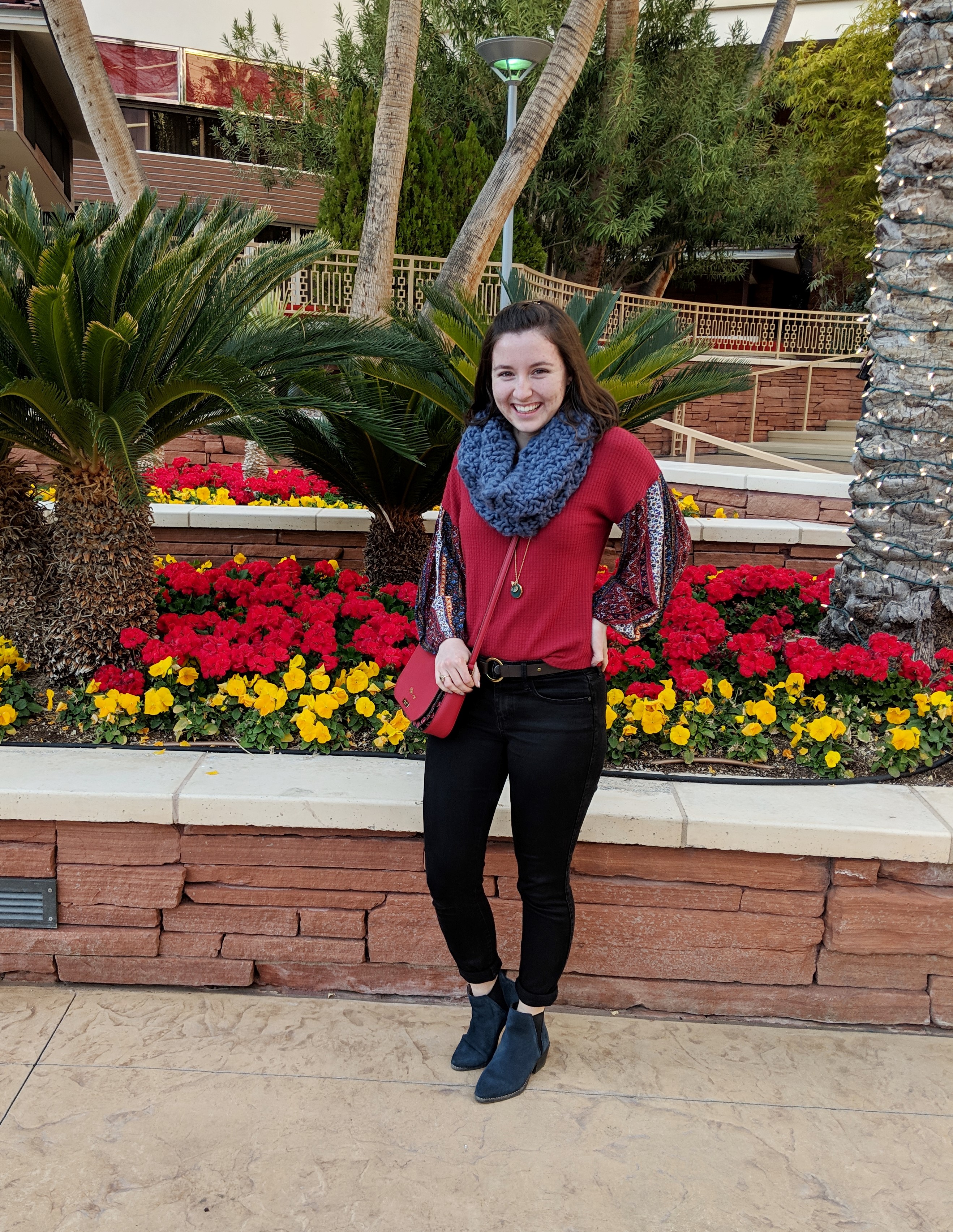 red patterned blouse and blue scarf