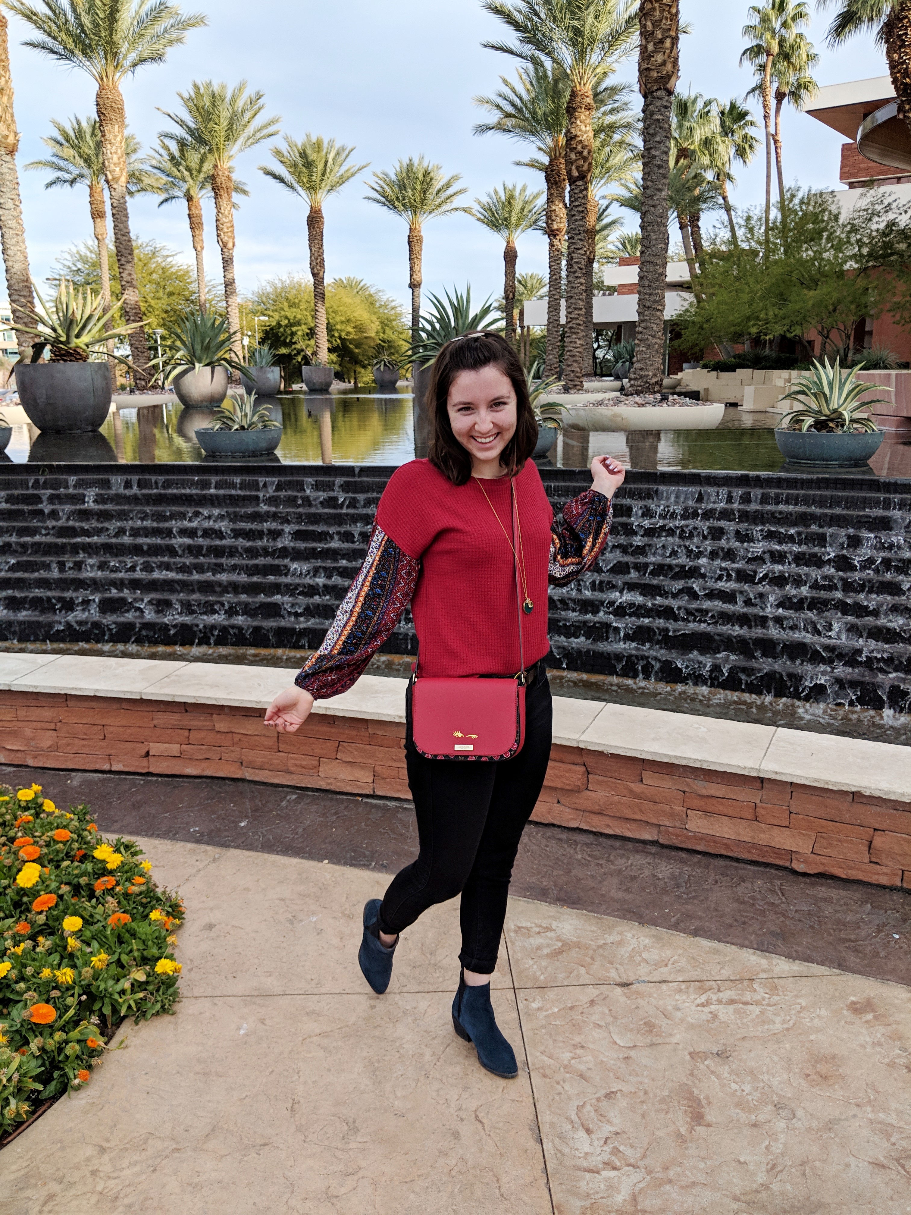 red peasant sleeve top with black pants