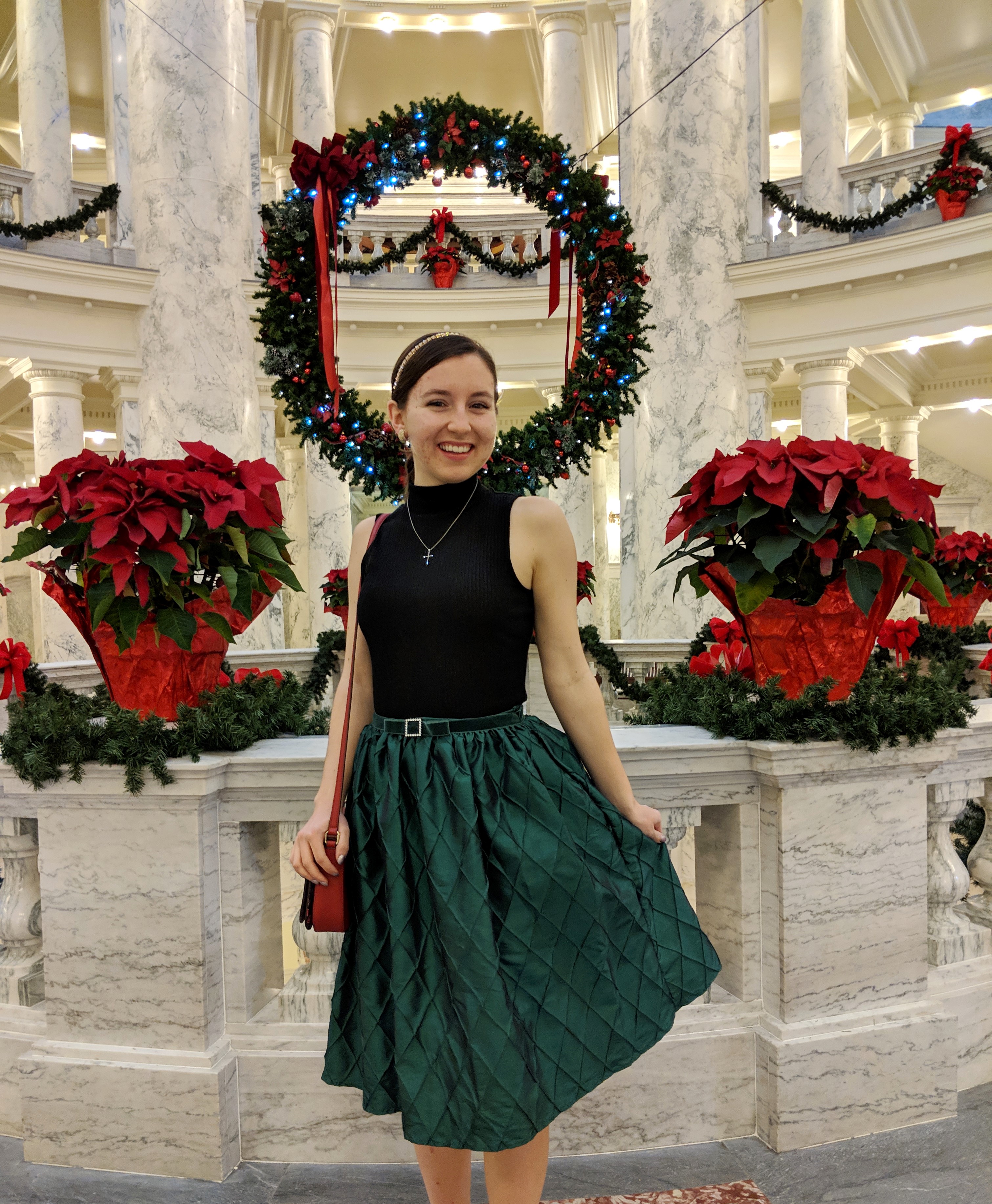 green skirt black mock neck top wreath
