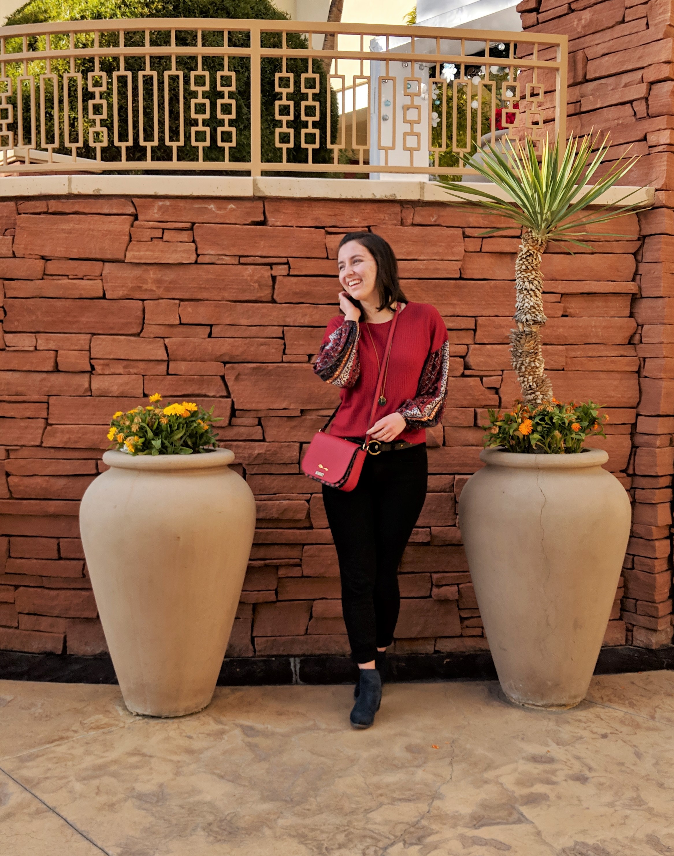 red Kate Spade purse black skinny jeans