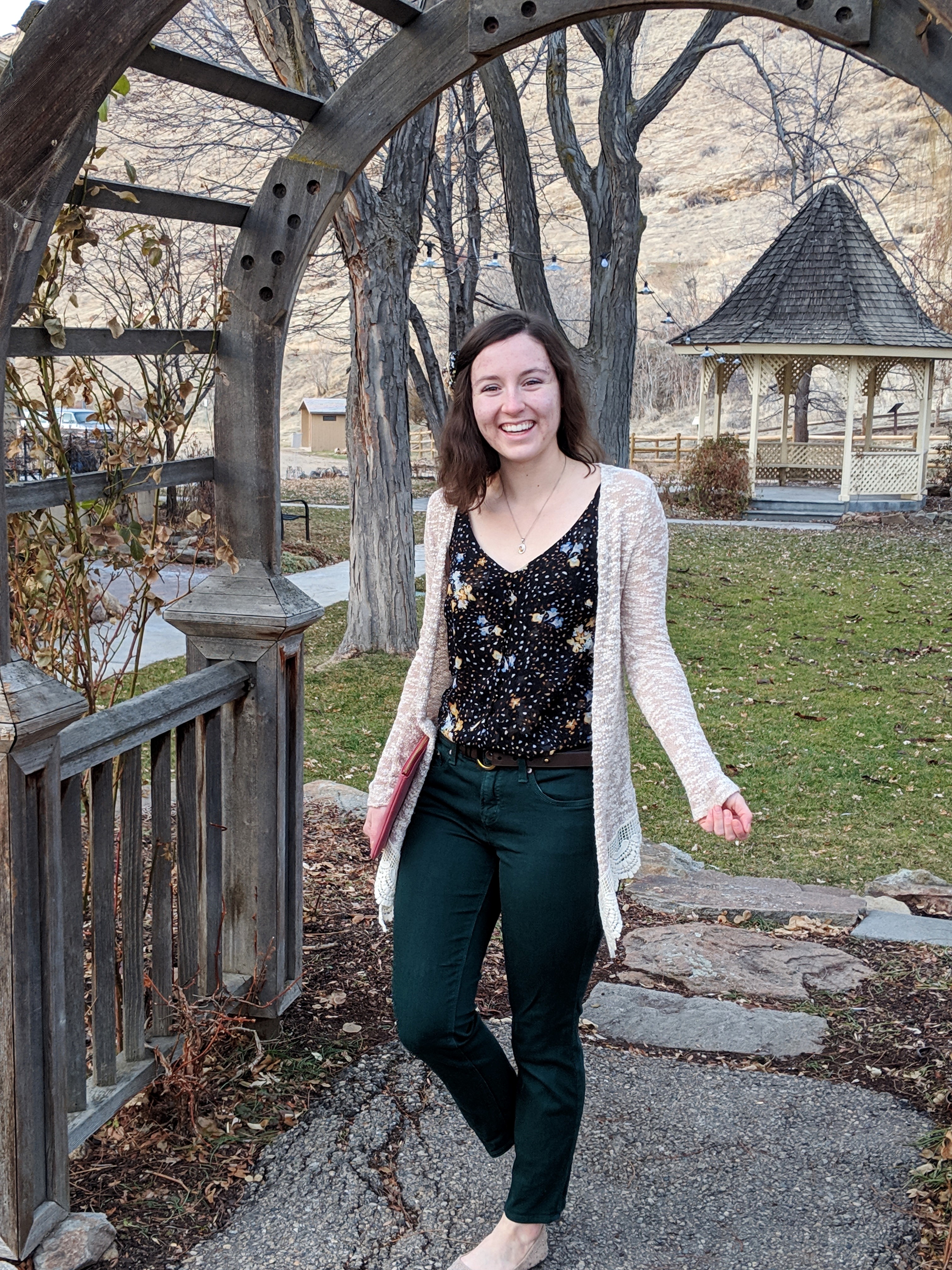 green pants and floral blouse with tan cardigan