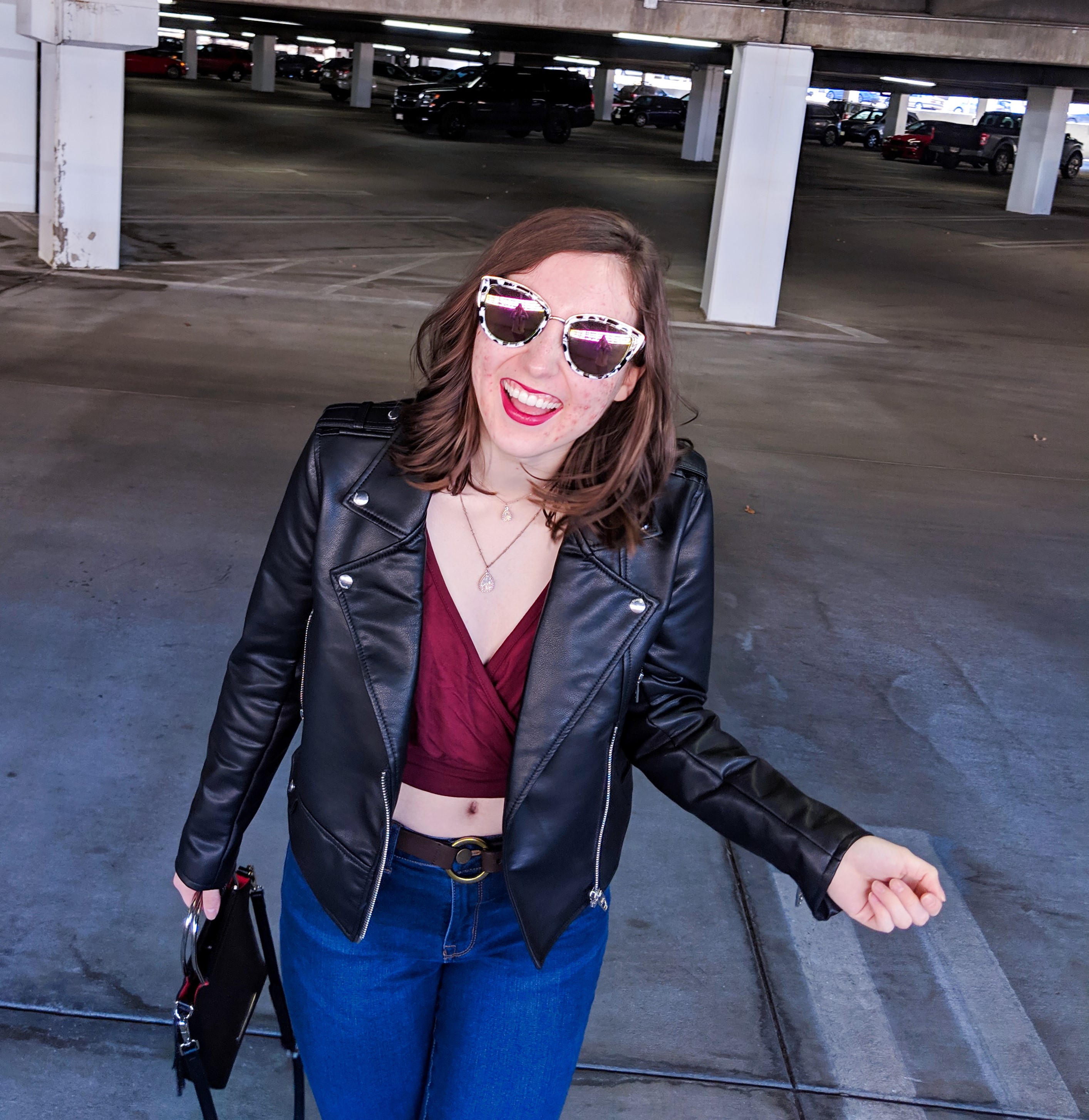 black pleather jacket and maroon vneck blouse
