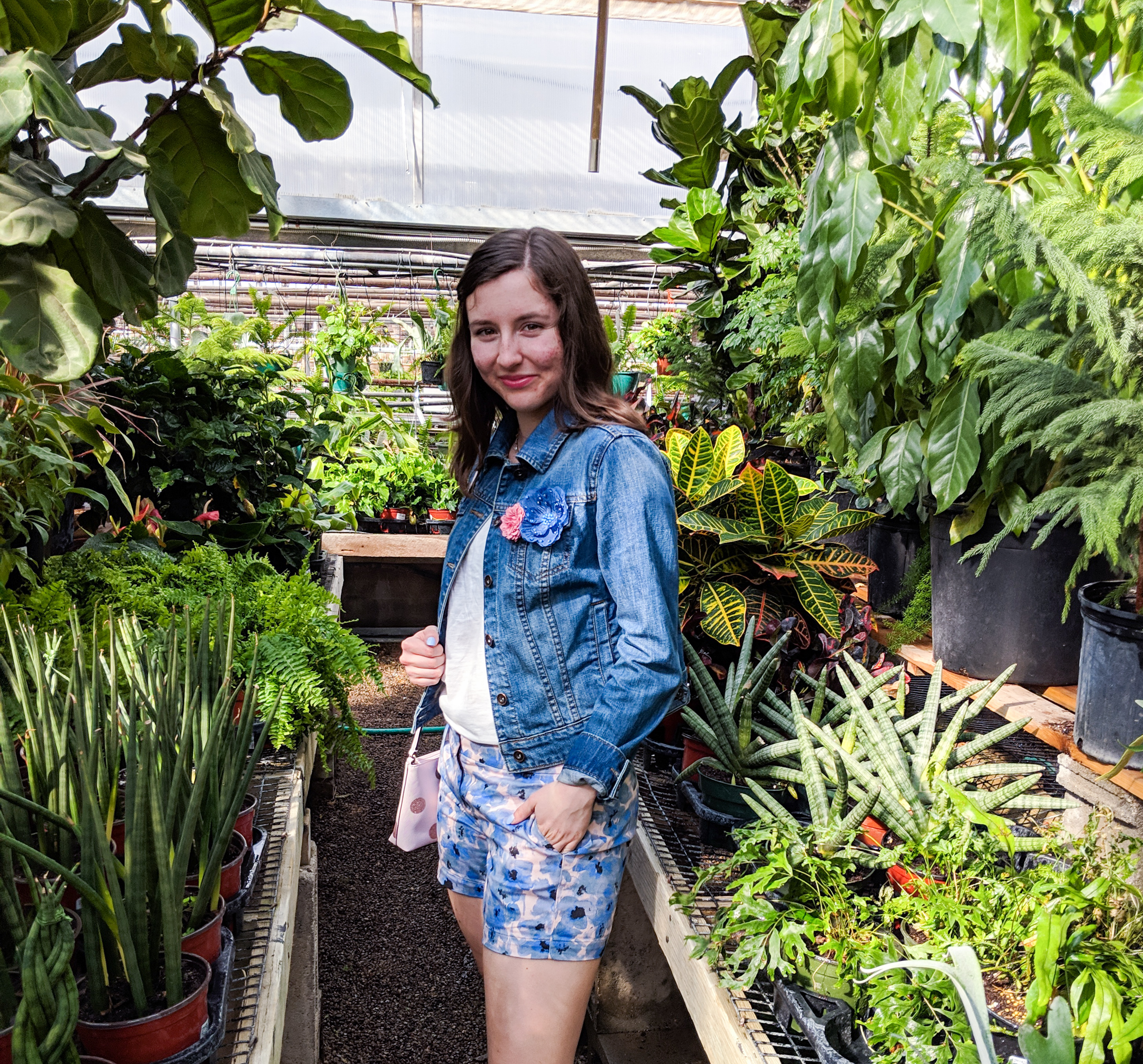 blue floral shorts from Loft, denim jacket, greenhouse photos, floral pins