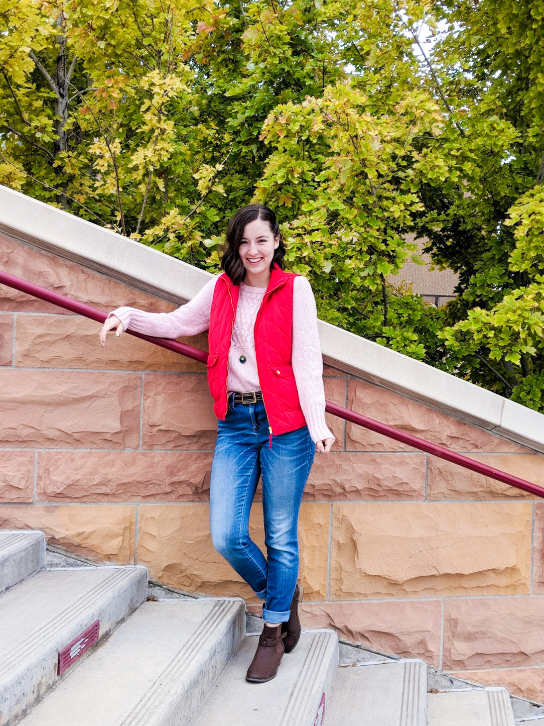 pink sweater, red vest, brown booties, skinny jeans