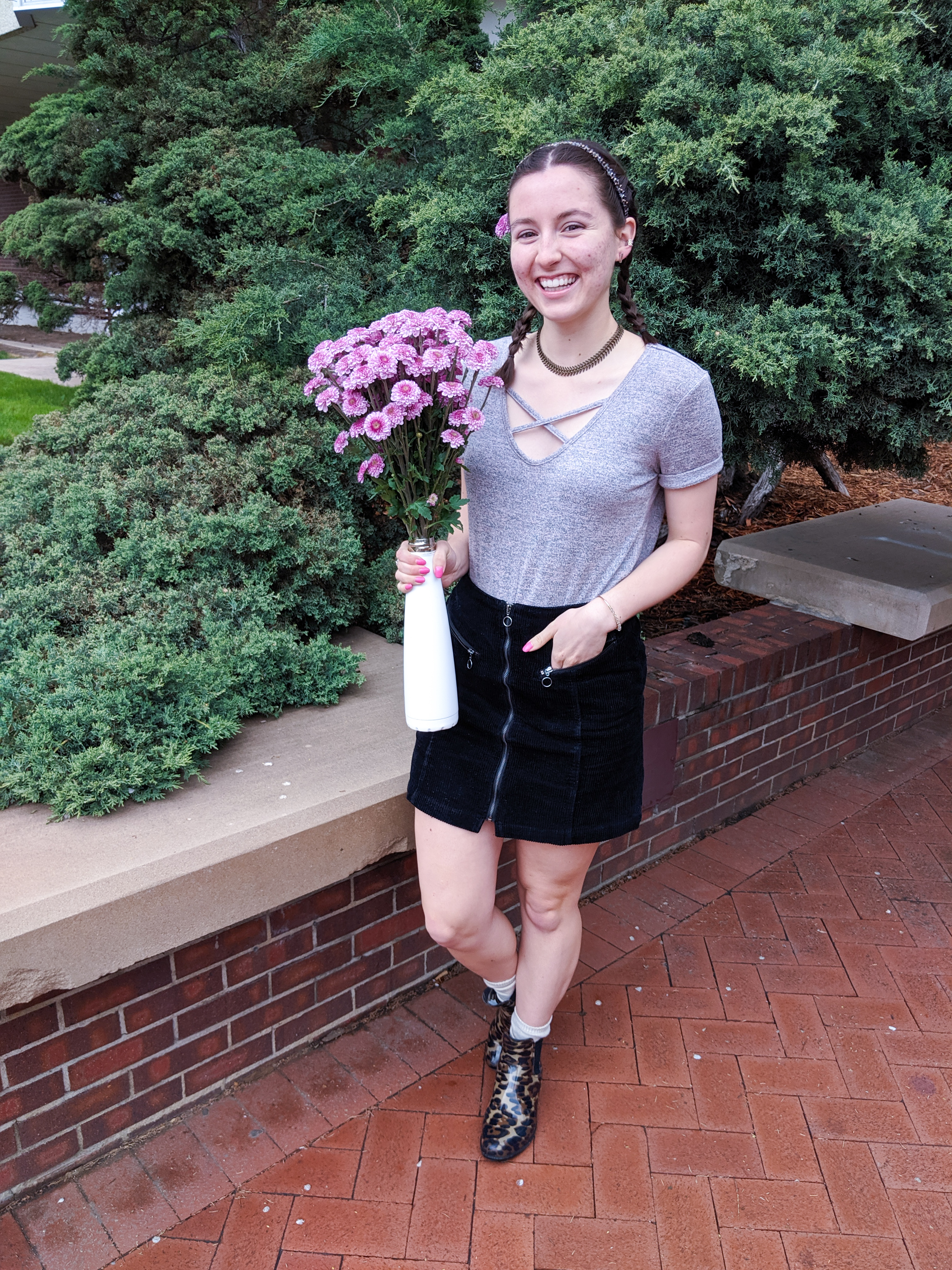 blush t-shirt, bouquet of flowers, black corduroy skirt, leopard booties