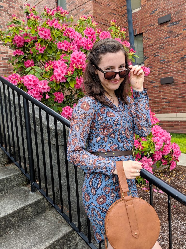 blue and brown dress, brown circle purse, brown belt, pink flowers