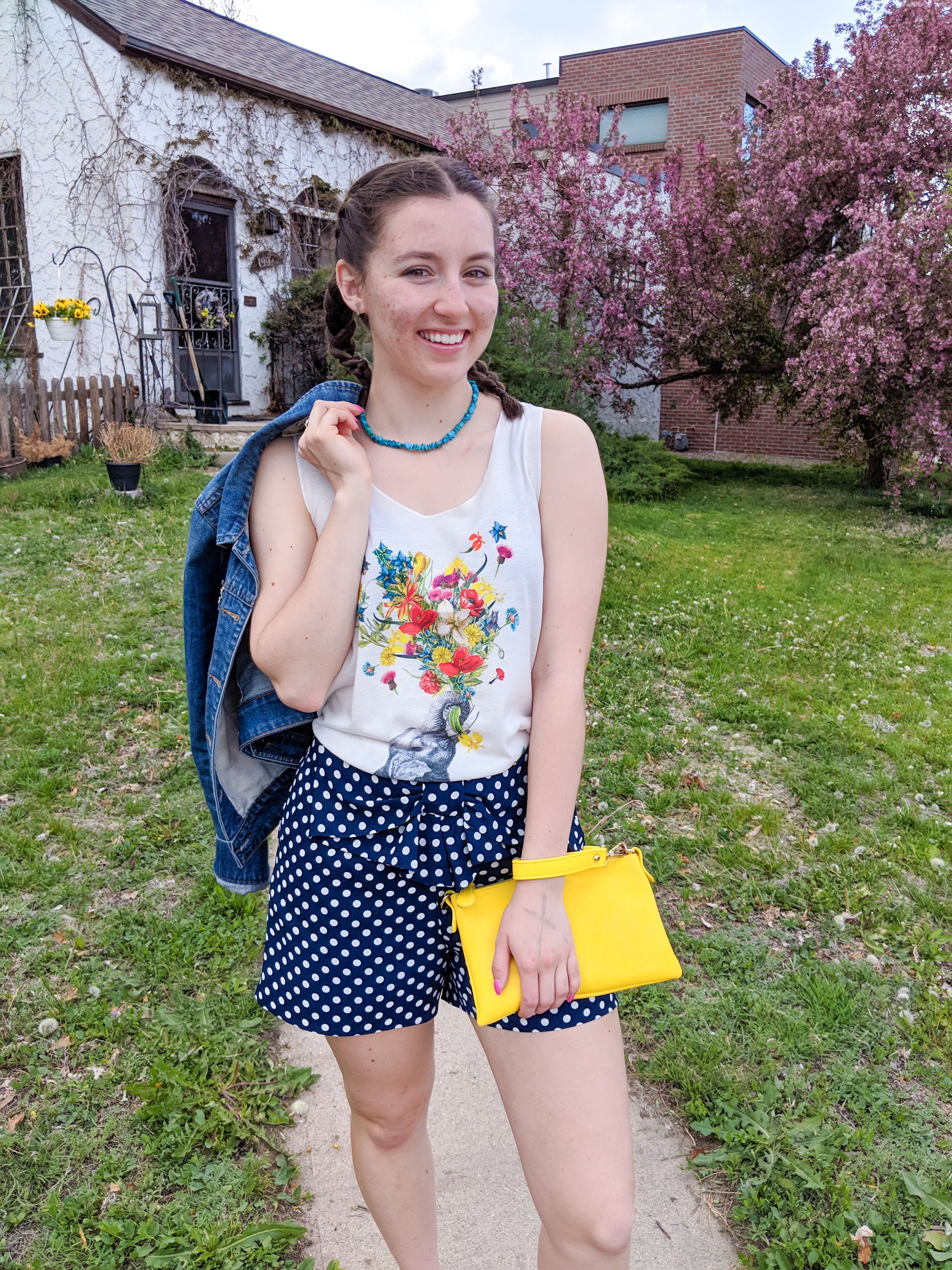 graphic tee, polka dot shorts, yellow purse, jean jacket