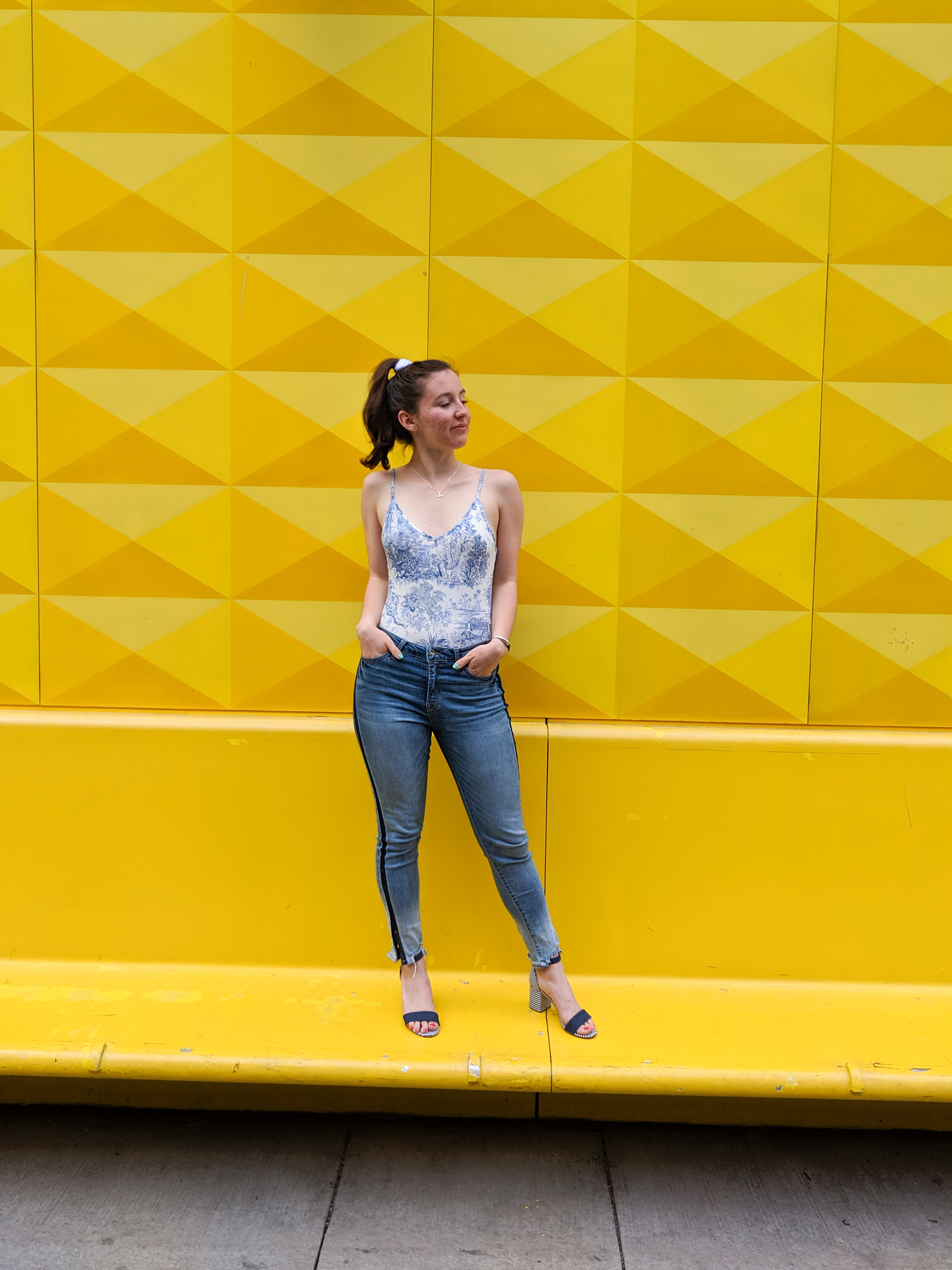 skinny jeans, bodysuit, yellow wall, downtown Denver