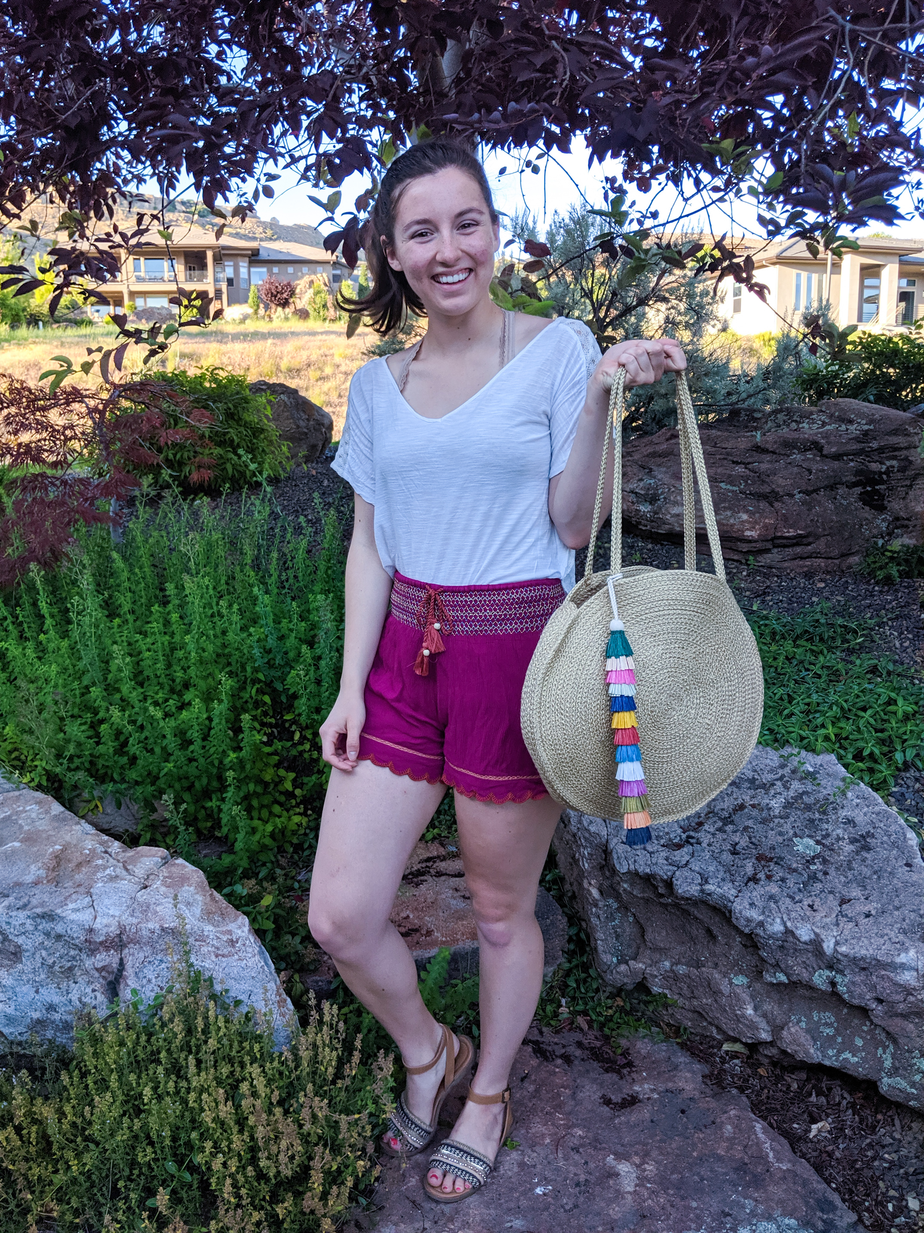 pink lounge shorts, brown sandals, wicker beach bag