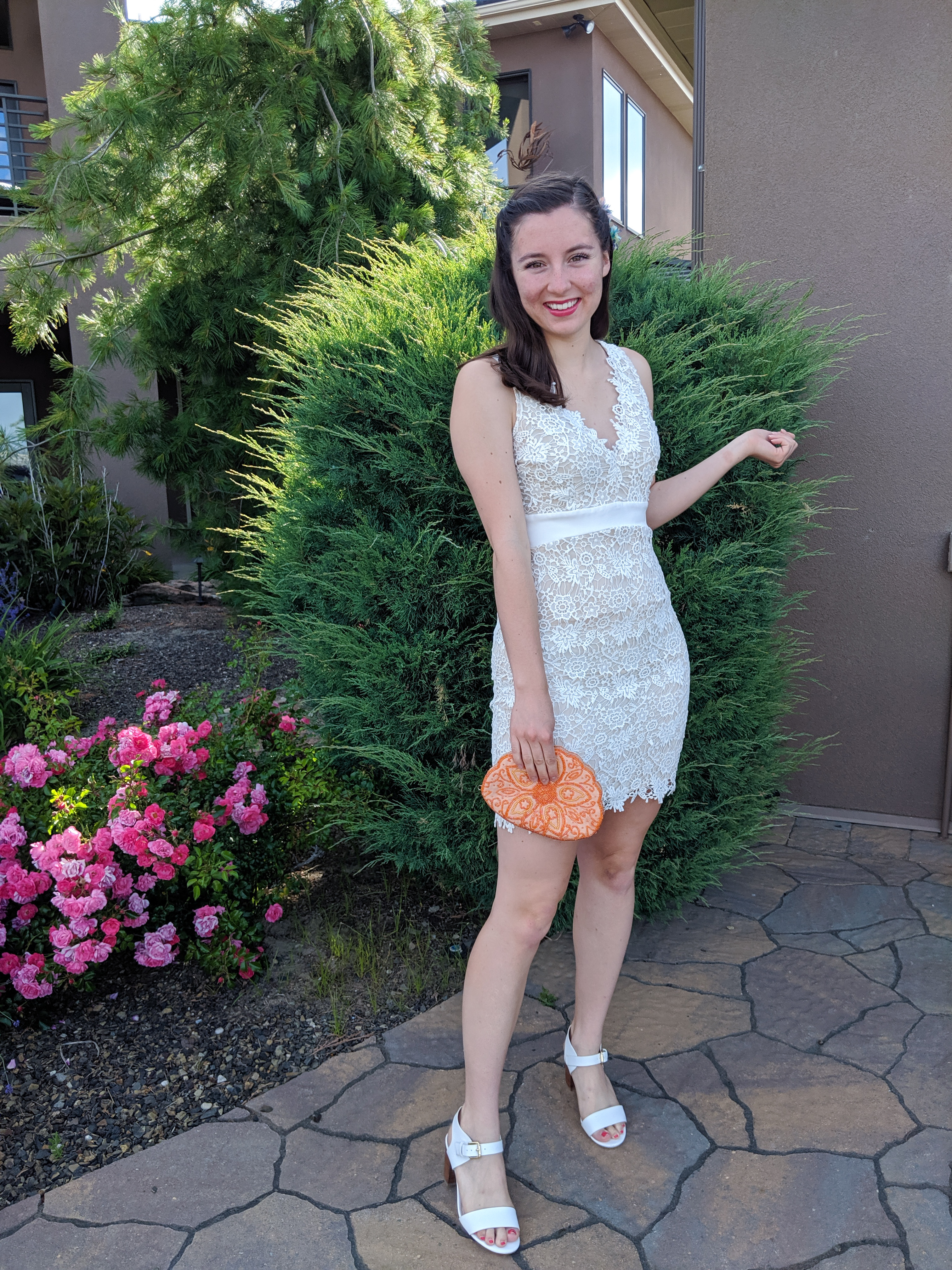 pink lipstick, orange beaded purse, how to style a white dress