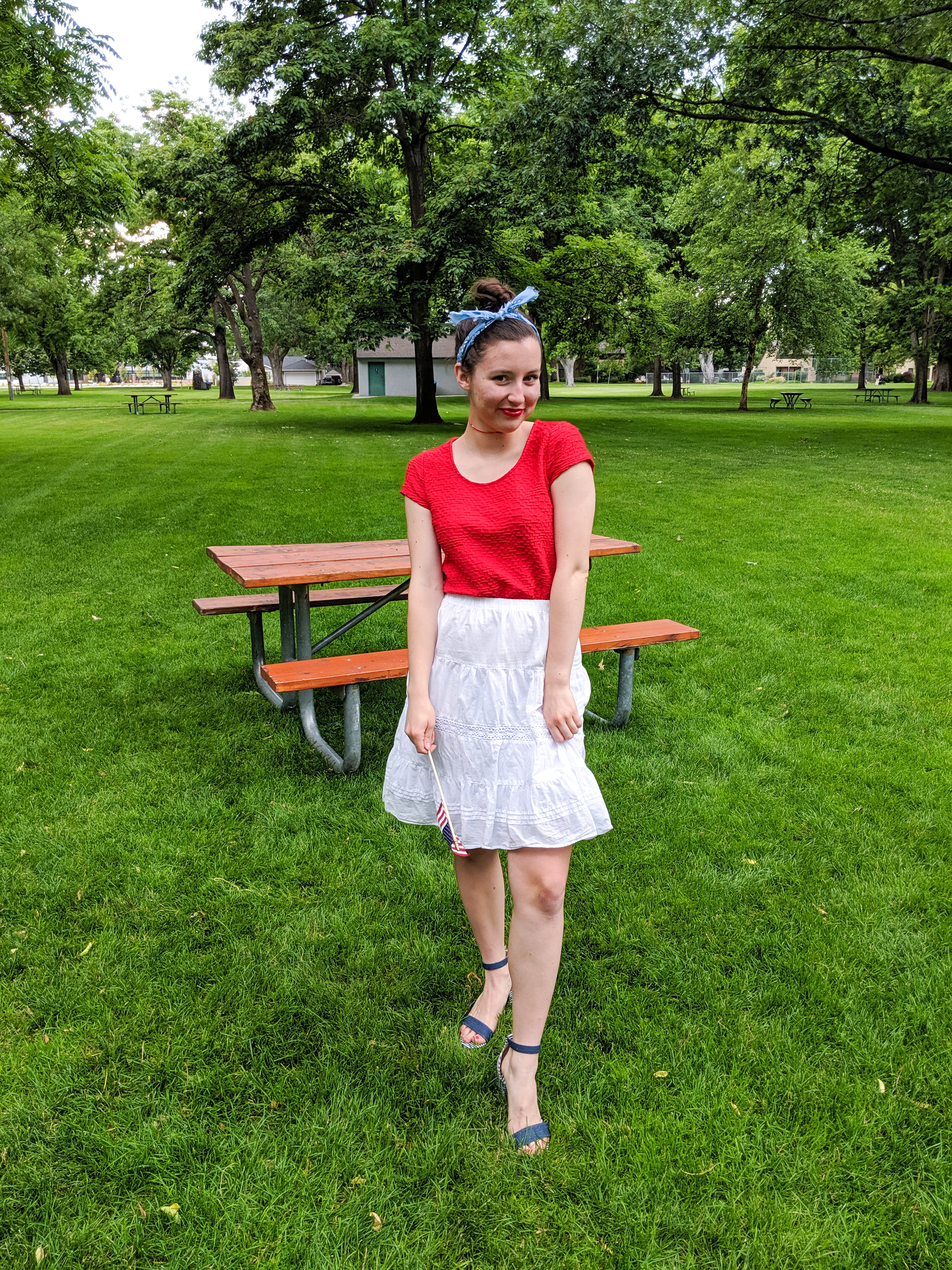 blue hair scarf, red shirt, white skirt, striped heels