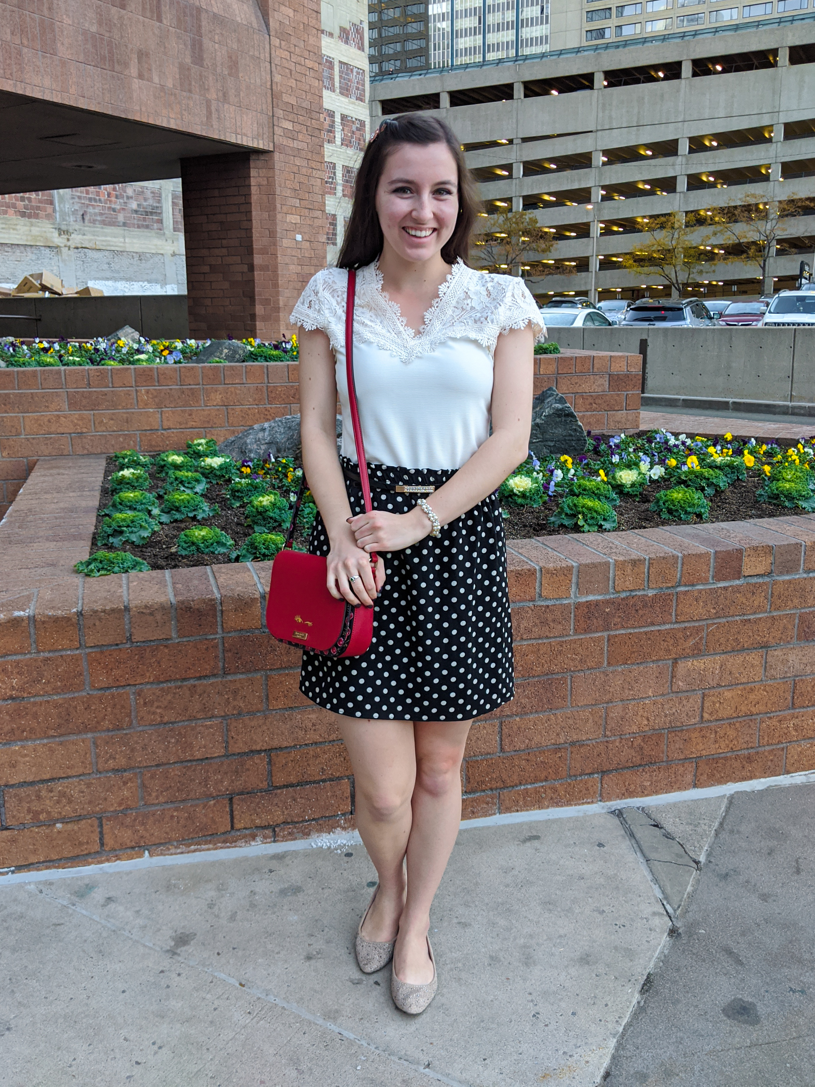 old fashioned blouse, polka dot skirt, red purse