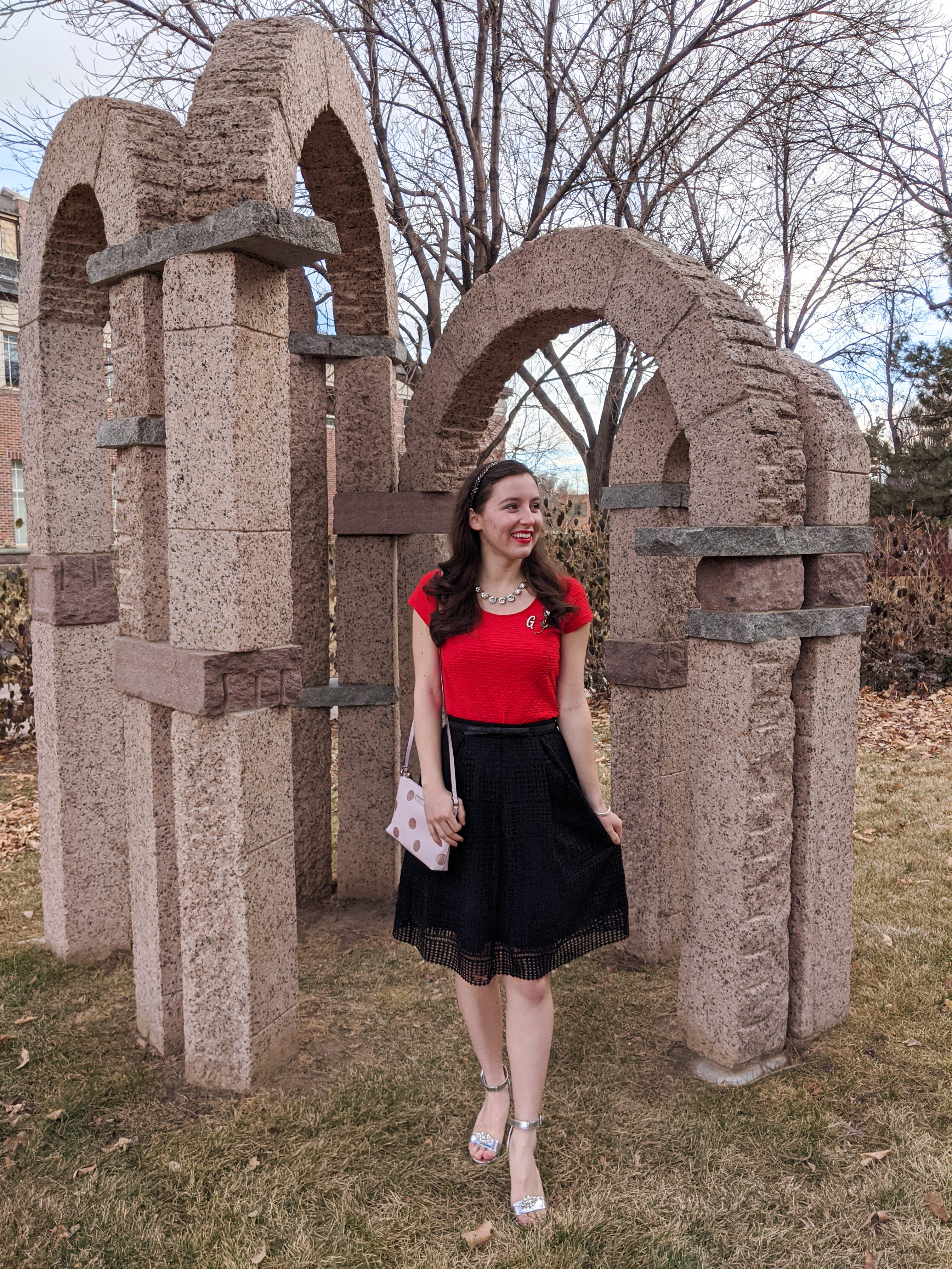 red blouse, black crochet skirt, silver heels, pink purse