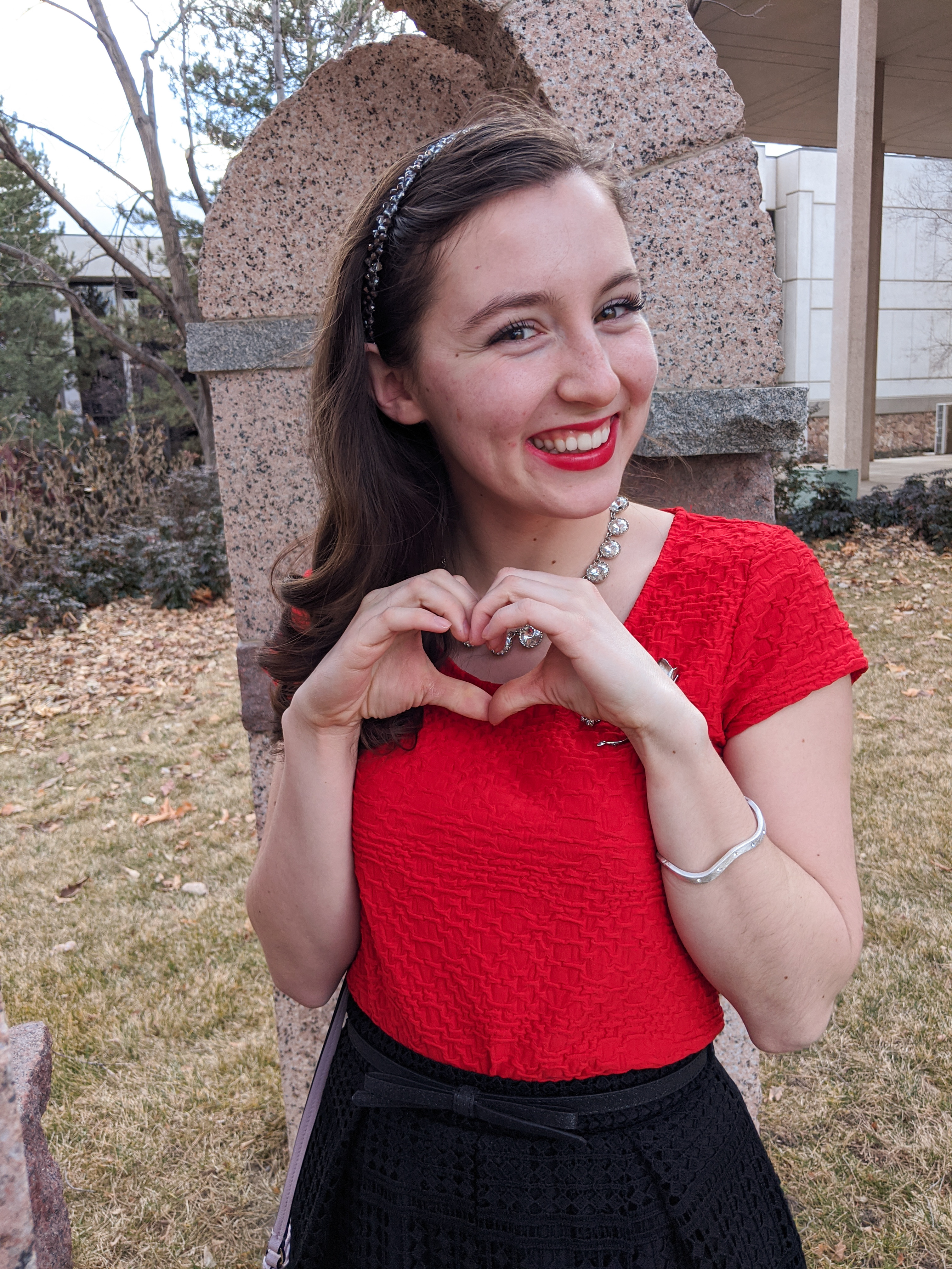 red blouse, silver accessories, bold red lipstick