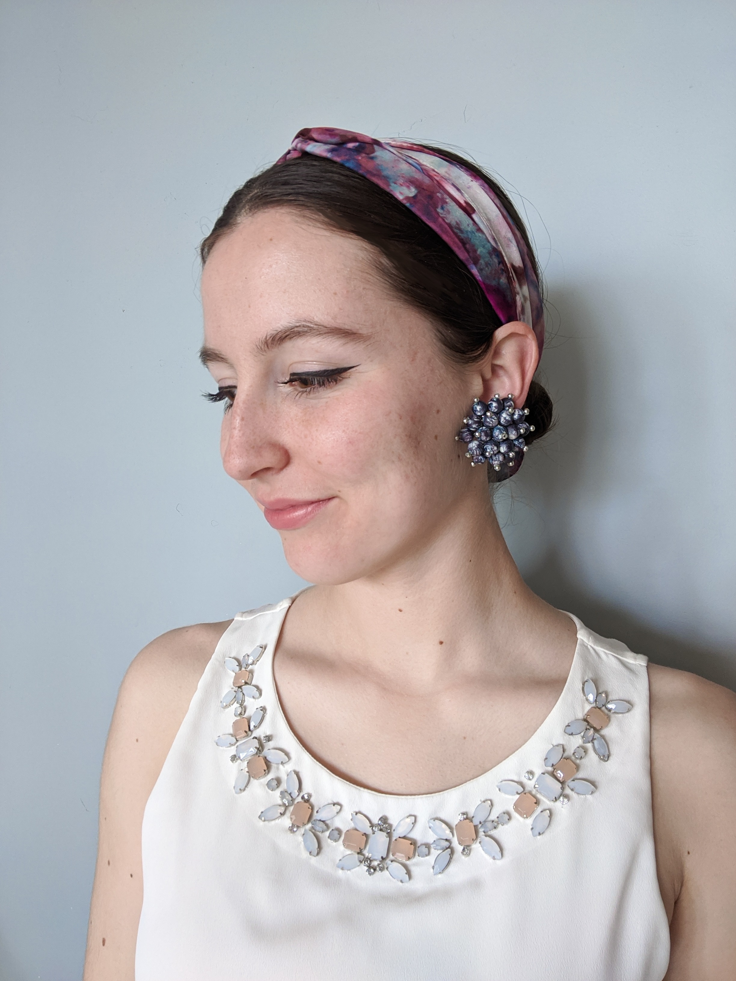 clip-on earrings, starburst earrings, hair scarf, bedazzled blouse, winged eyeliner