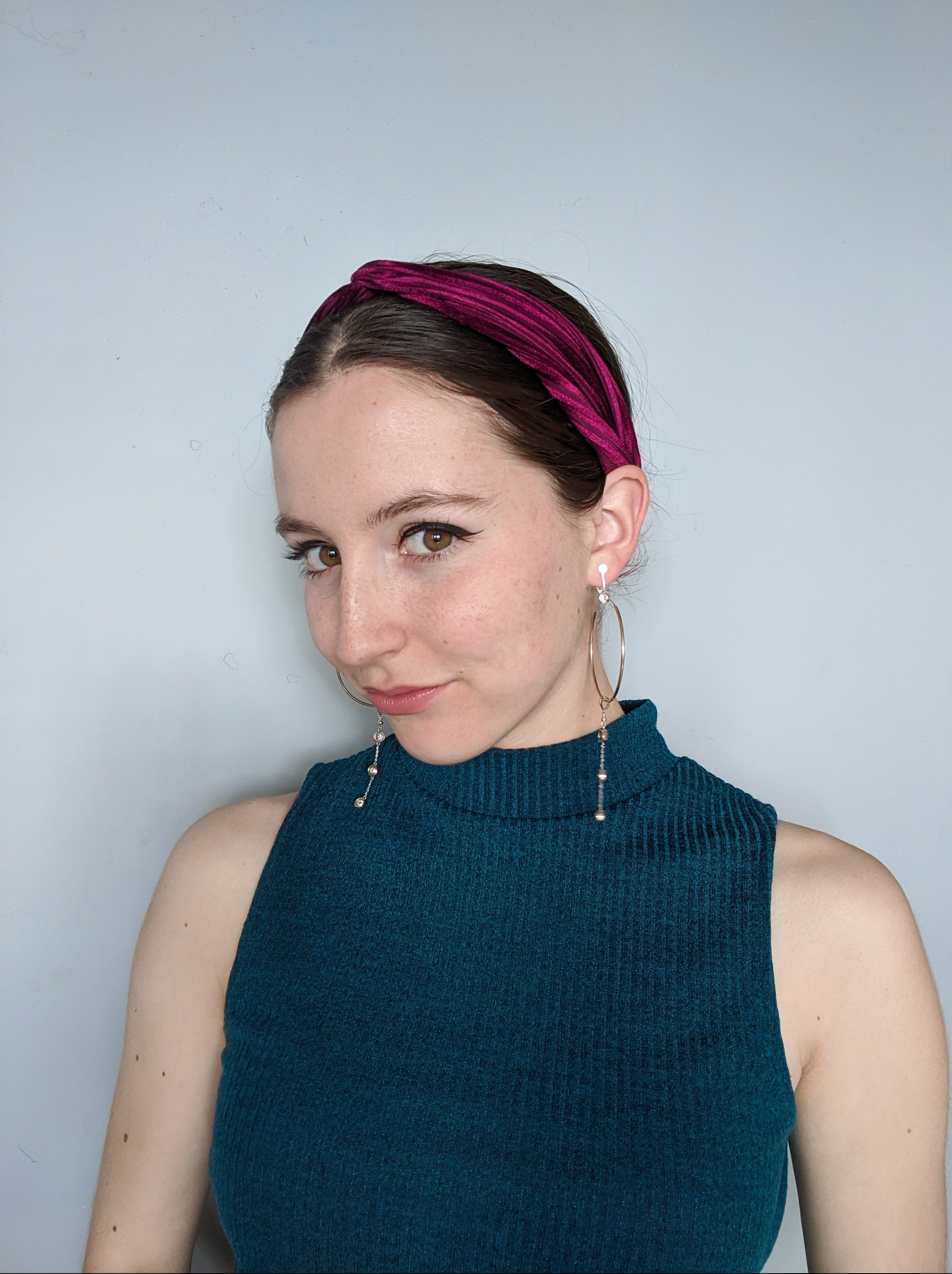 hoop earrings, teal mockneck top, jewel tones, black eyeliner