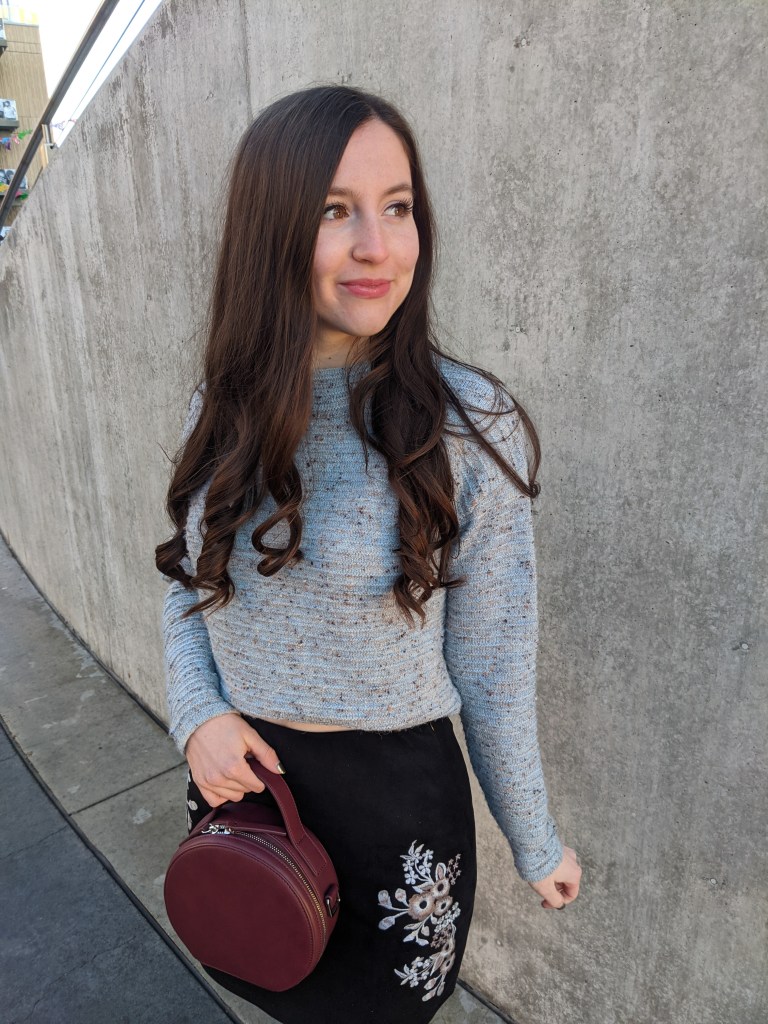 blue-sweater-maroon-purse-embroidered-skirt