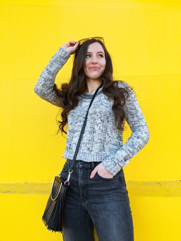 grey-sweater-express-jeans-black-crossbody-yellow-wall