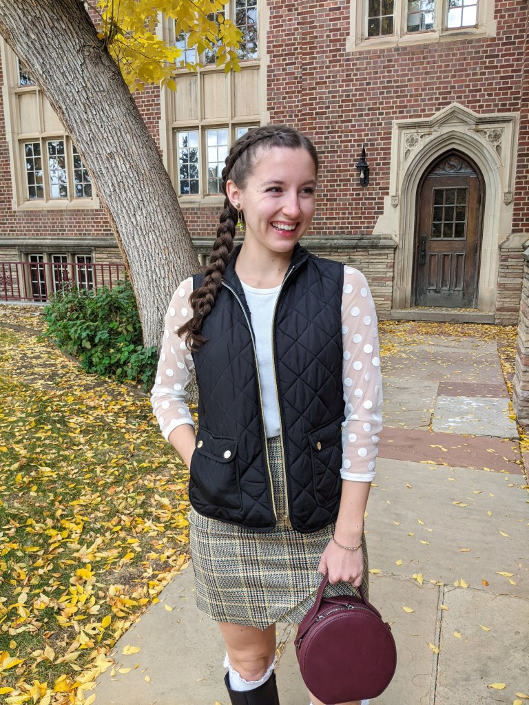 black-quilted-vest-mesh-sleeve-top-plaid-skirt