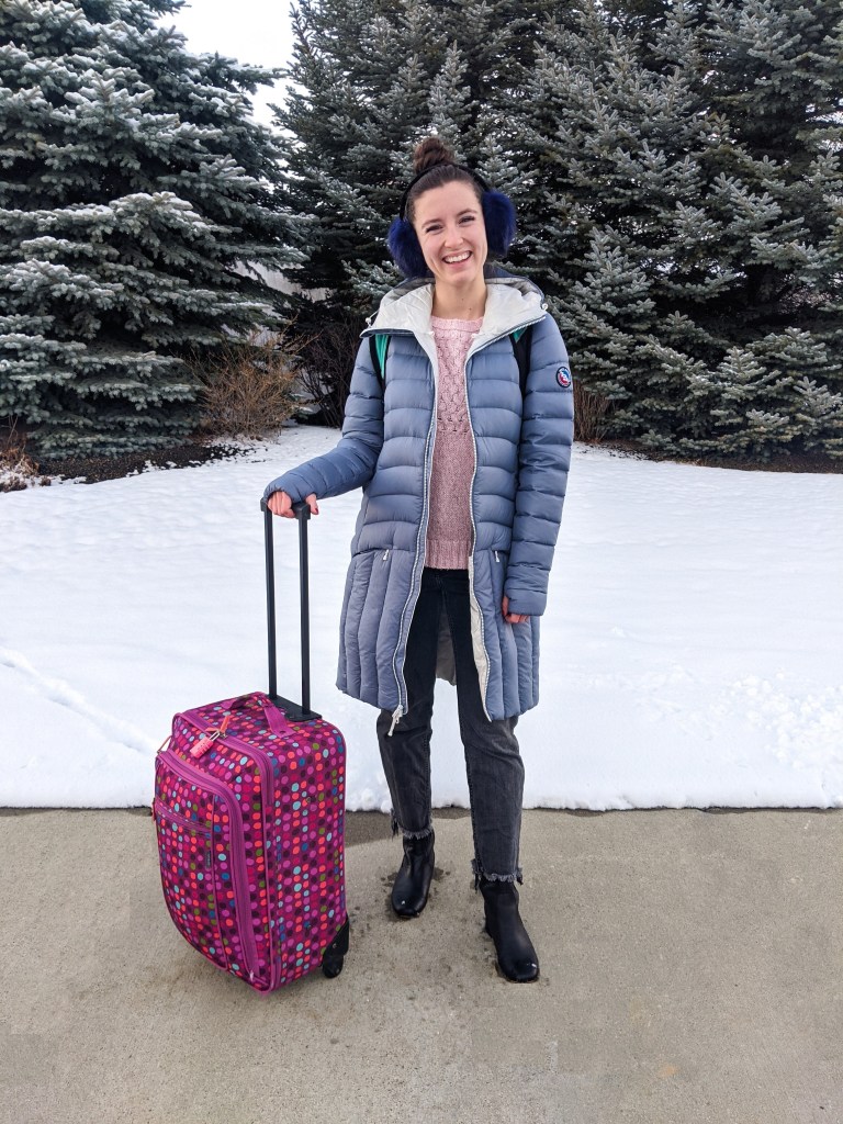 blue-long-puffer-coat-suitcase-packing