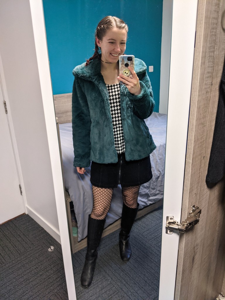 checkered-top-teal-fur-coat-fishnet-tights-black-knee-boots