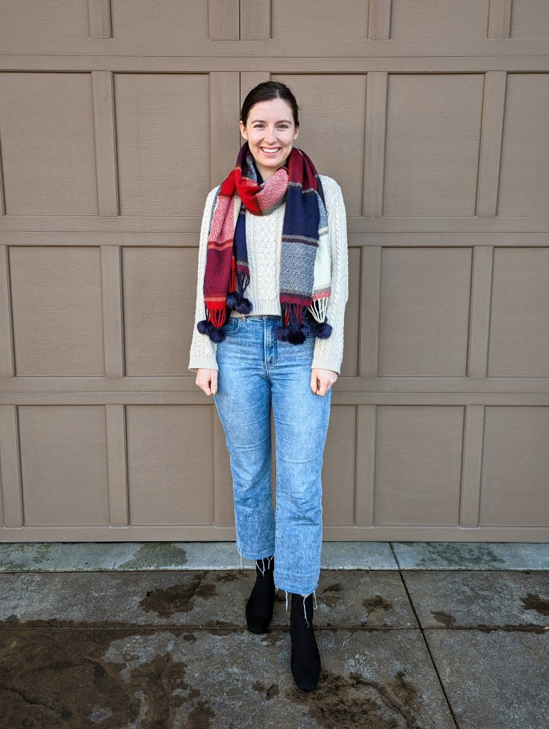 beige-sweater-plaid-scarf-pom-poms-cropped-flared-jeans-black-booties-vivaia