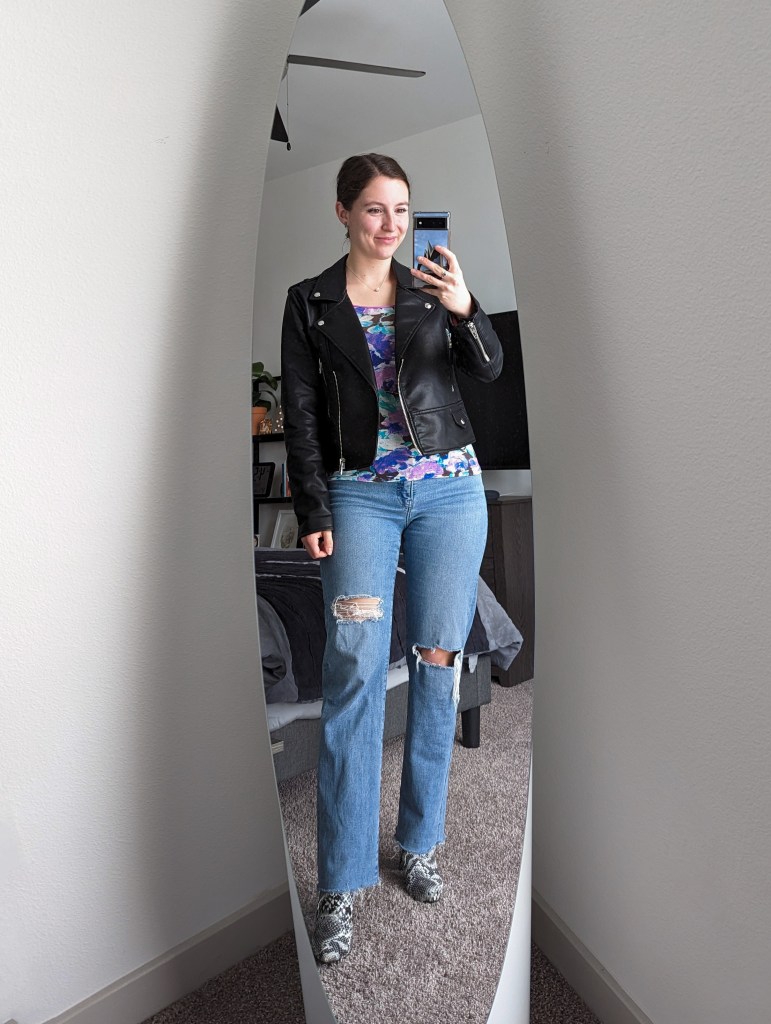 ripped-straight-leg-jeans-black-leather-jacket-floral-top-snakeskin-booties