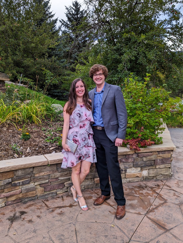 fall-wedding-outfit-floral-tiered-dress-silver-heels-clutch