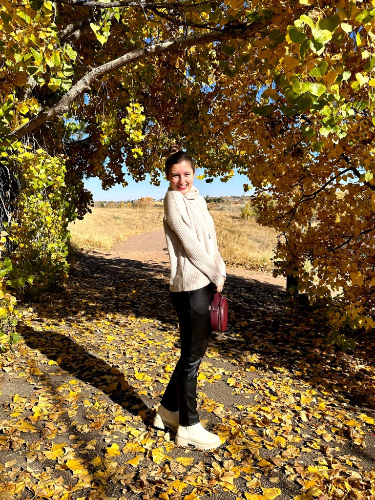 clara-sunwoo-black-leather-pants-beige-turtleneck-sweater-maroon-circle-purse