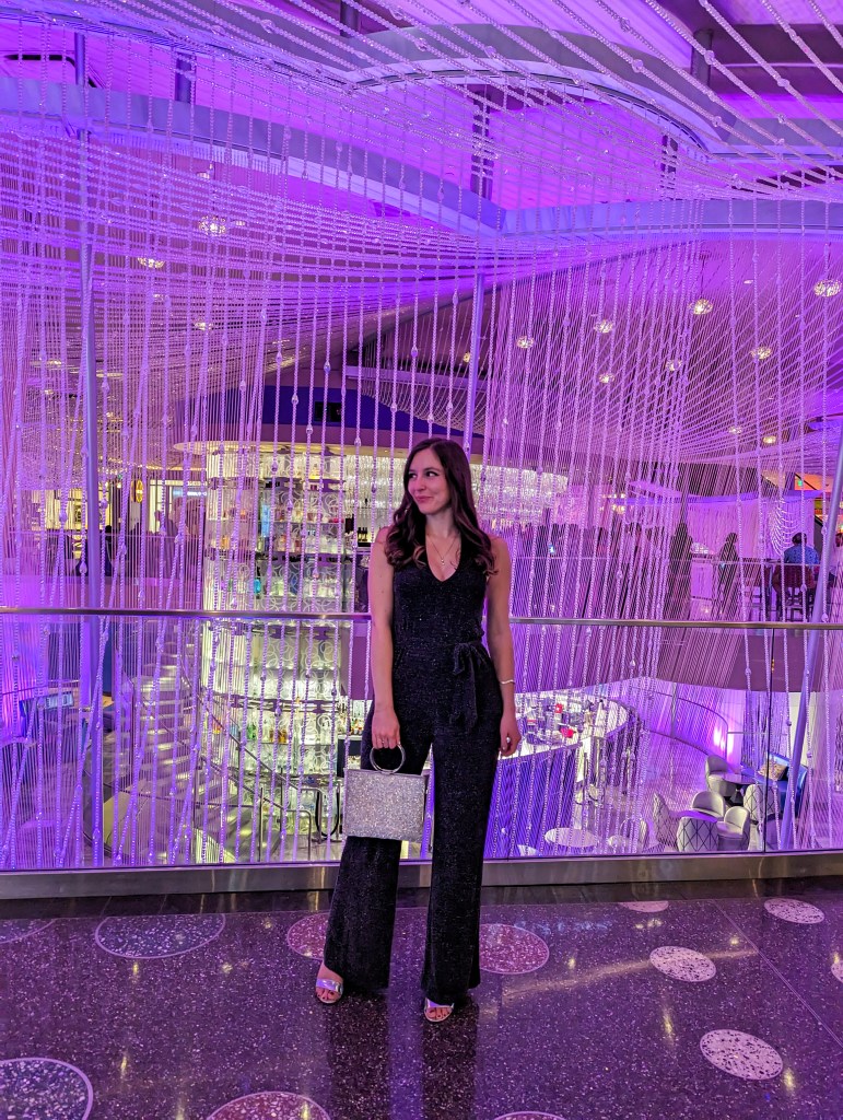 black-sparkly-halter-neck-jumpsuit-silver-purse-heels-going-out-gambling-outfit