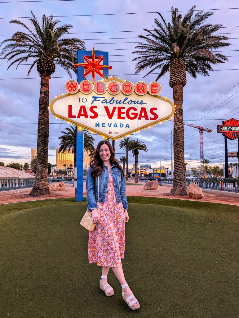 las-vegas-sign-floral-old-navy-dress-denim-jacket-wicker-purse-white-sandals