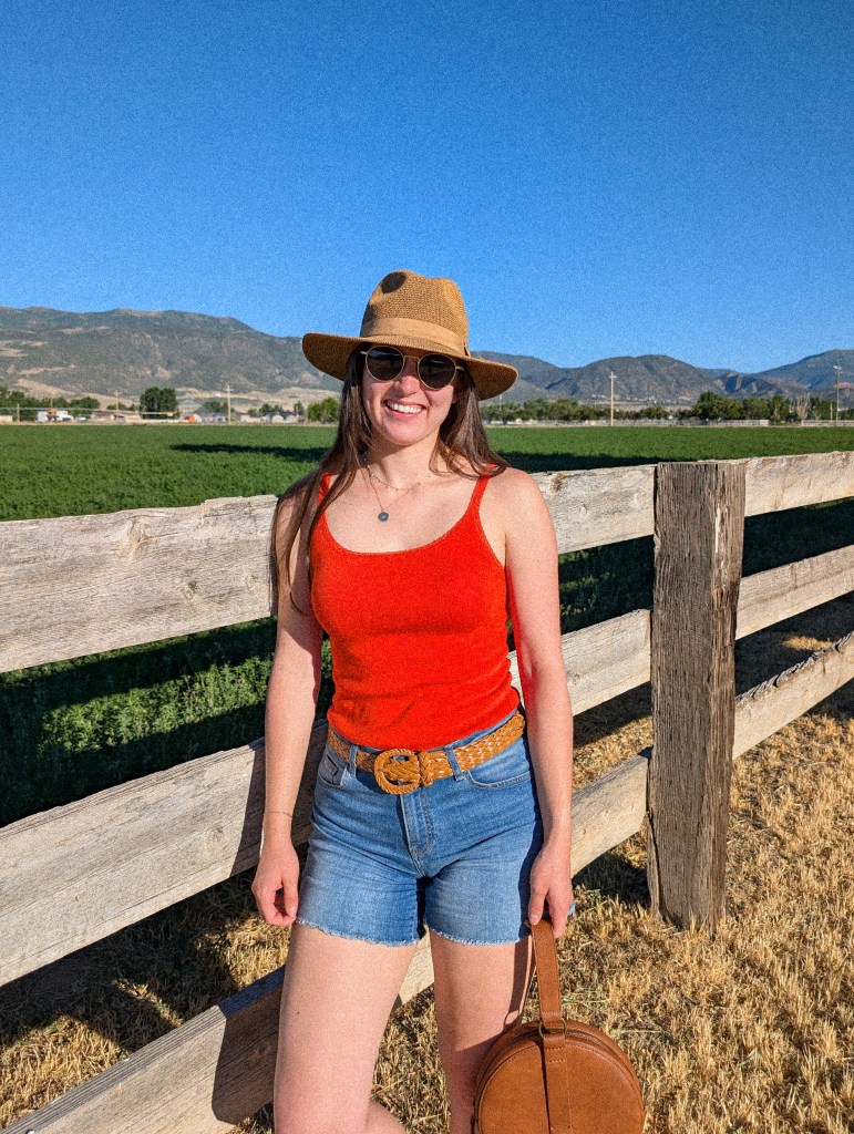 orange top panama hat denim shorts thrifted belt sungait sunglasses