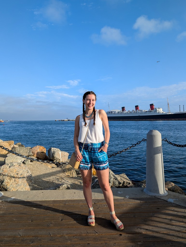 white blouse turquoise shorts sandals summer outfit vacation style