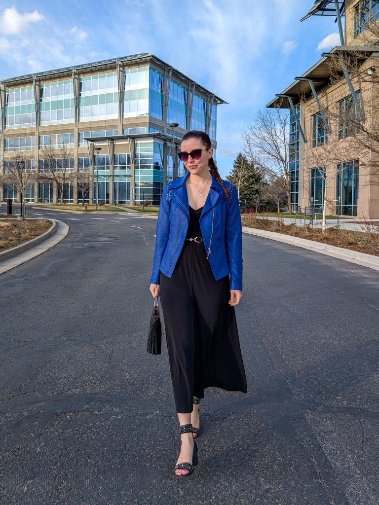 black jumpsuit flowy studded heels cobalt blue jacket silver chain belt