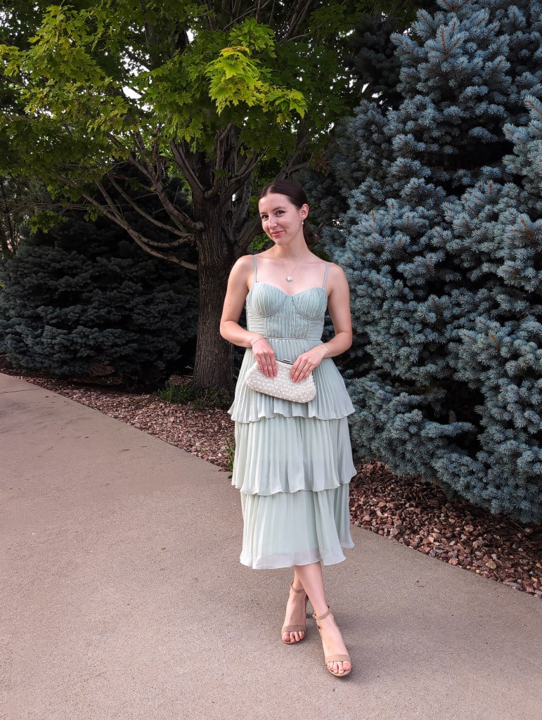 sage green dress tiered bridesmaid wedding guest dress nude heels pearl clutch