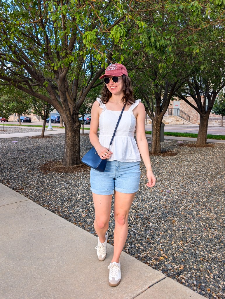white peplum top summer outfit light wash denim shorts sneakers