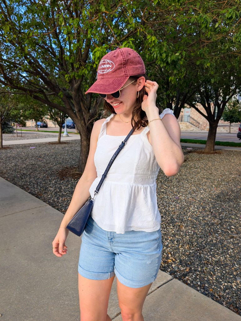 red Lumon hat Severance white peplum top polka dots gold earrings